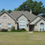 front view of a house with trees at the back