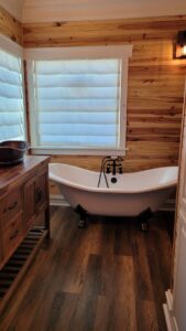 a bathtub in the bathroom near windows