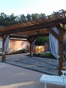 an outdoor seating area with curtains