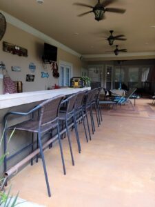 a kitchen area with black chairs