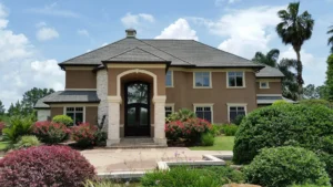 Beige two-story house with landscaped front yard